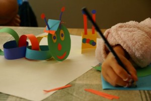DSC08496 organe made a caterpillar. She made him a hat. She made him a book. She put antennae on the book so the caterpillar would know it was friendly.