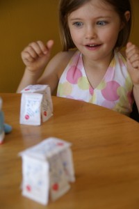 My talented daughter teaches me to make a house out of bags of sugar.