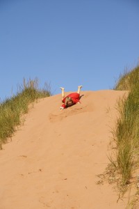 Morgane discovers sand-dune surfing. Is this why her ears are so sandy?
