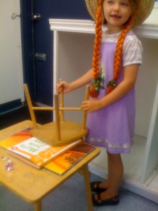 Morgane plays school at the laundromat. I am Miss Stacey.