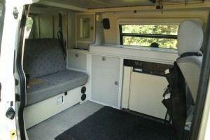 This seat folds down into one bed. You can also see the fridge - the stove is above it.