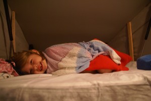 Morgane curled up in the pop-top with a toothless smile.