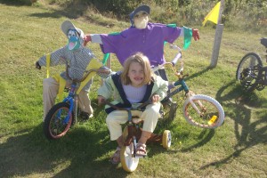 Morgane posing with two of Joe's Scarecrows.