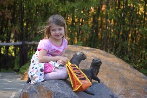 Morgane poses with otters at the zoo.