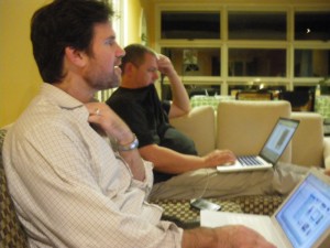 The guys on the couch, watching baseball and doing computer stuff.