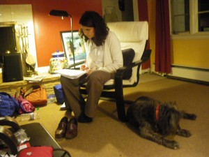 Mariamalia correcting her students' biology homework. That's Negrita by her chair.