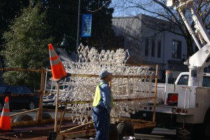 A city worker in Chapel Hill installs festive snowflakes. With the hot weather, it seemed kind of surreal.