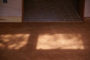 The floor is dirt, but finished with a mix of essential oils and other natural stuff. It feels neat to walk on because of the little bumps and imperfections, but it's quite clean.