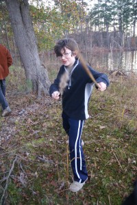 Tom sword fighting with tall grasses.